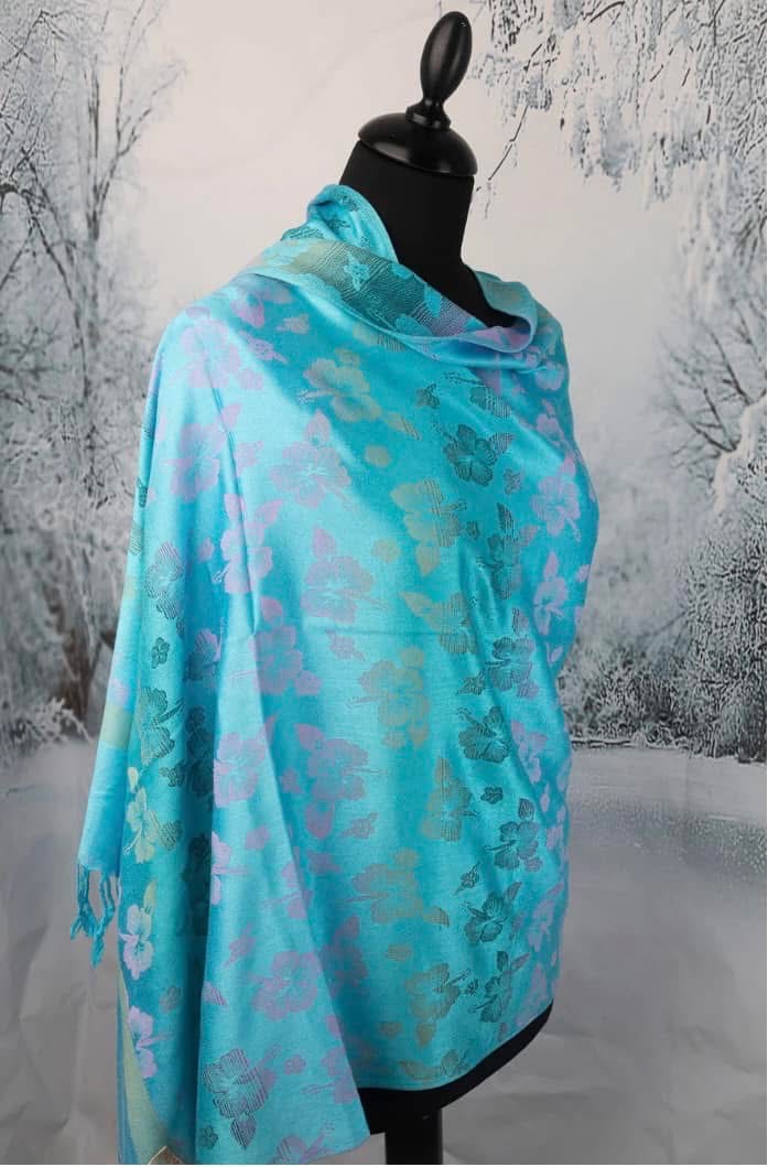 Blue and turquoise floral cashmere scarf styled on black mannequin
