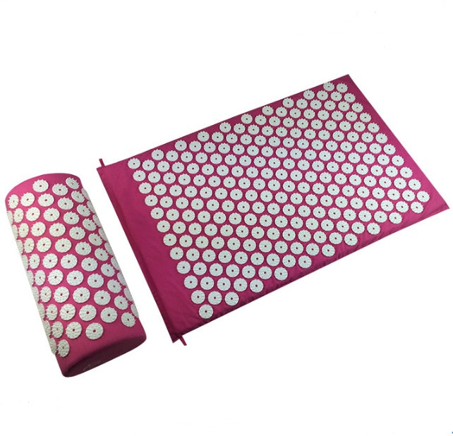 Acupressure mat and pillow with pink and white floral patterns on a white background