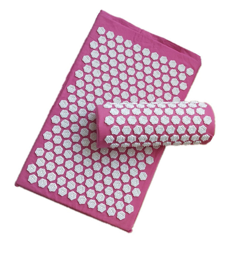 Pink acupressure mat with white hexagonal pressure points on a white background