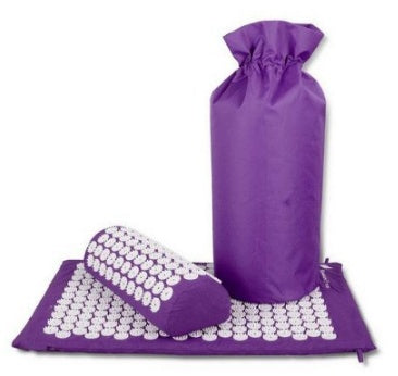 Purple acupressure mat with a pillow on a white background