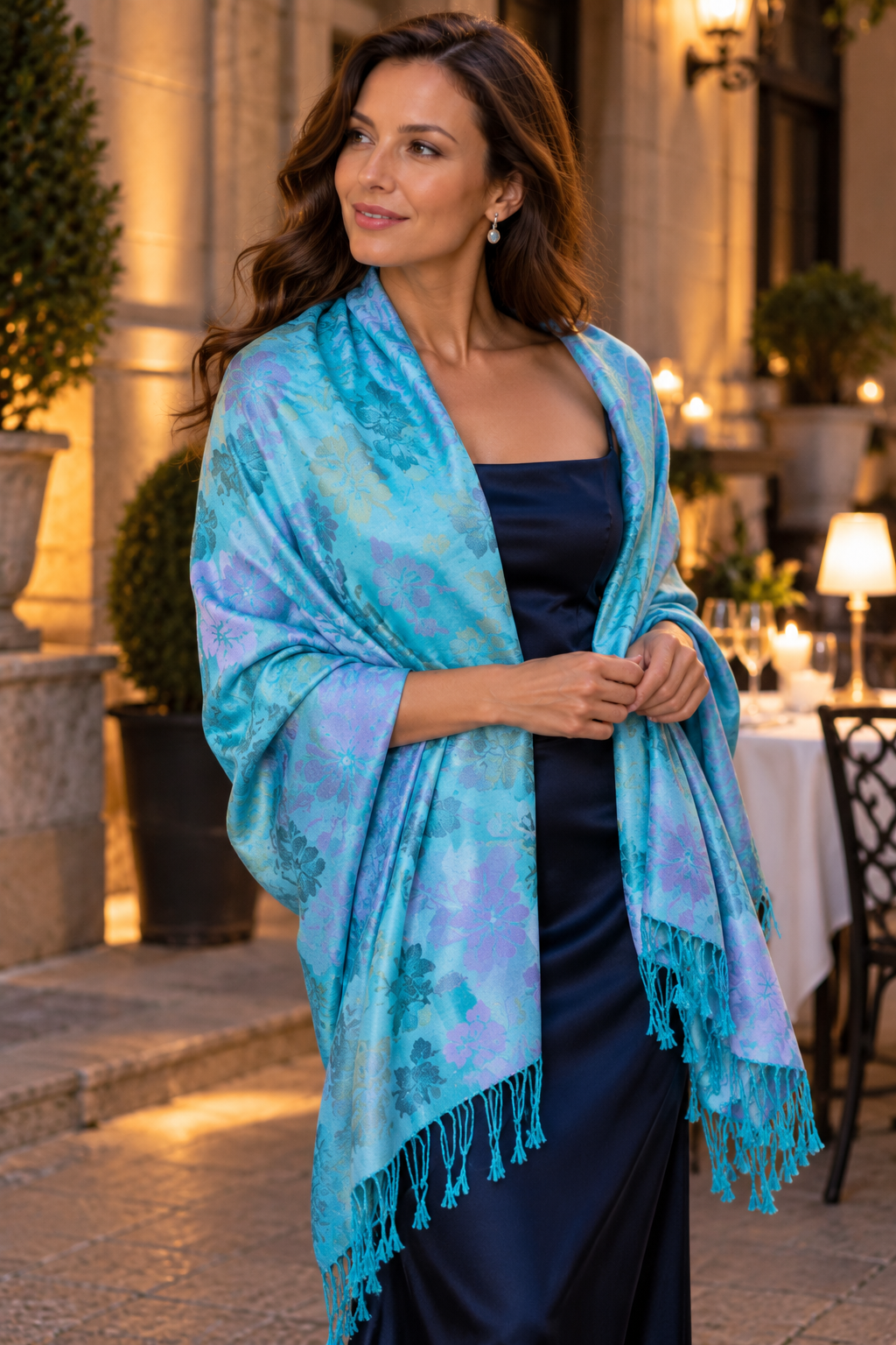 Woman wearing blue floral cashmere shawl as an elegant evening wrap