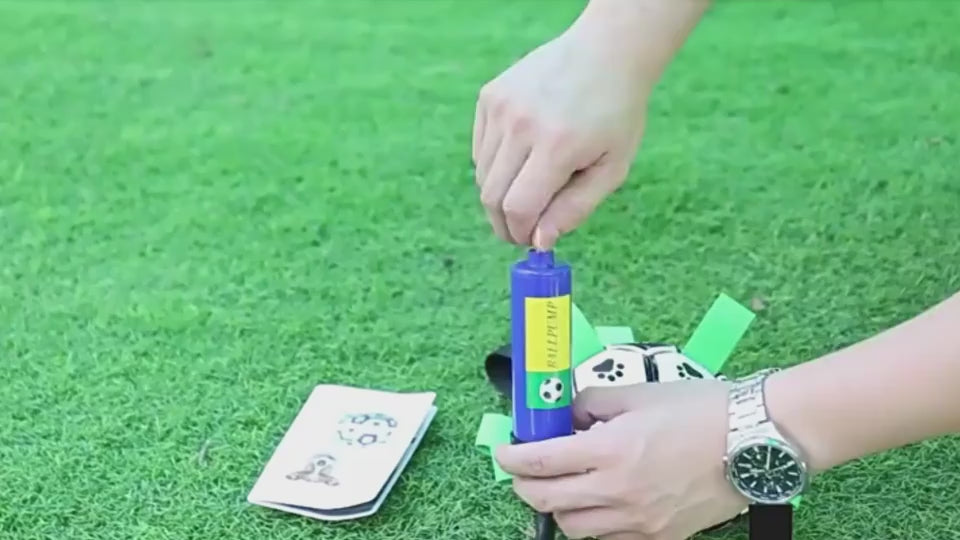 Inflatable tool with green carabiner, black pump, and brown ball-like object on a white background. video 2