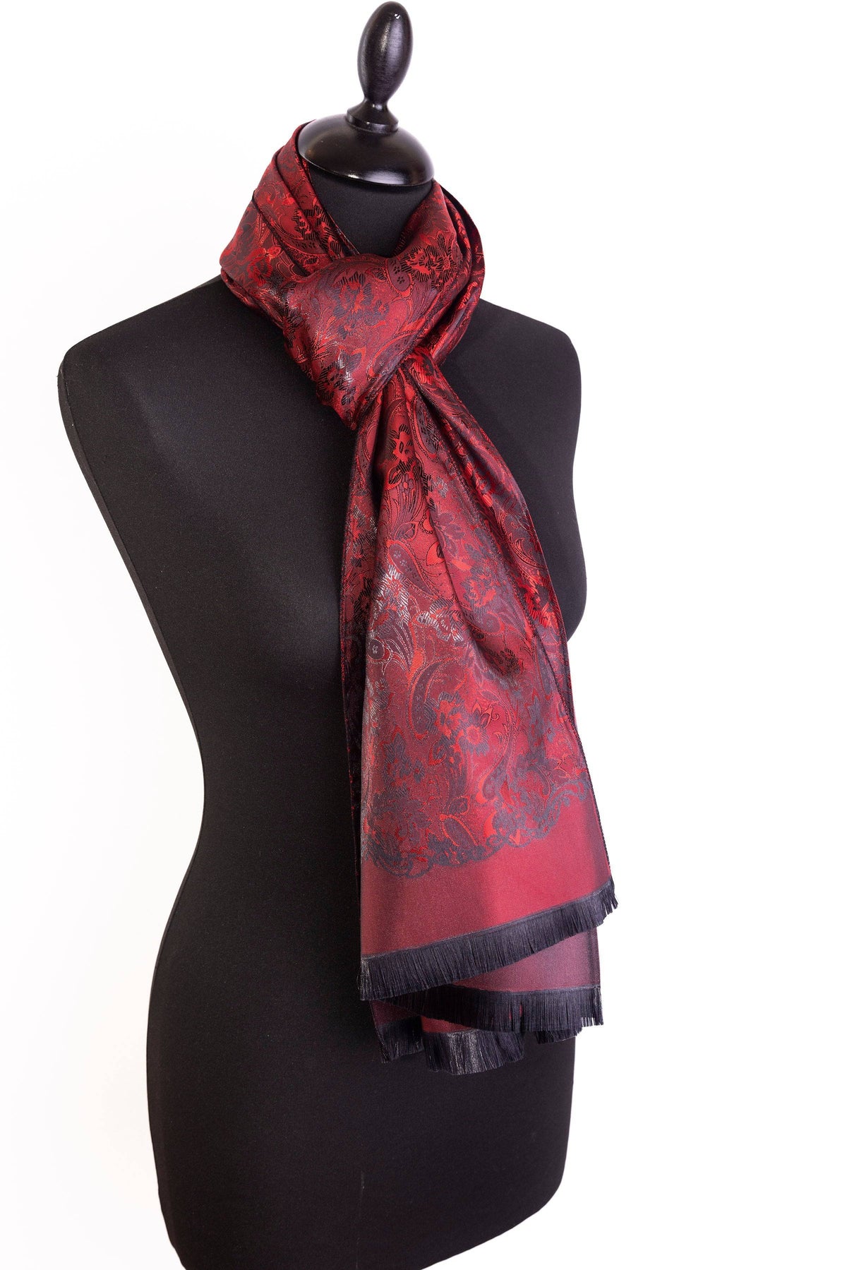 Close-up of red and burgundy paisley pattern on 100% silk scarf